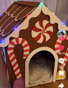 a dog house made out of cardboard and decorated with candy canes