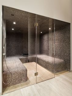 a bathroom with a walk in shower sitting next to a bathtub and tiled walls