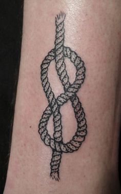 a black and white photo of a tattoo with a knot on it