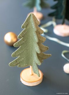 a small green christmas tree sitting on top of a table