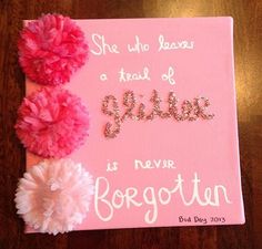 a pink sign with two pom poms on it and the words she who leaves a trail of sparkle is never forgotten