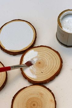 the paint is being applied on wood slices