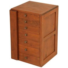 a wooden cabinet with five drawers on one side and two doors on the other end