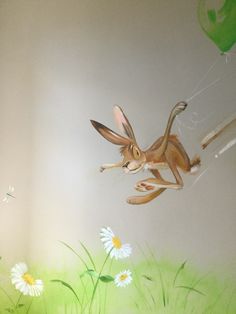 a painting of a rabbit flying through the air with balloons and flowers in the background