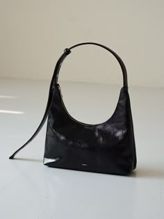 Editor's NotesEcrit creates basic and essential bags with minimal and timeless design in mind. - 2-way shoulder bag (tote/shoulder)- Coated material that is resistant to scratches- Gloss finish to boost your outfit- Adjustable shoulder strap Measurement (inch)One Size- Body: 11.81 in. (W) / 5.51 in. (H) / 2.95 in. (D)- Strap: 27.56 in. (Length) / 9.84 in. (Drop)Composition & Care- Outer: Polyurethan vegan leather / Lining: Polyester- Avoid direct heat and moisture- Do not wash- Avoid fire- Dry with a dry cloth when wet- Avoid direct sunlight- Professional cleaning recommendedDesigner- by ECRU 90s Minimalism Fashion, 90s Bag, Simple Leather, Black Purse, Black Leather Purse, Essential Bag, Black Shoulder Bag, Mini Shoulder Bag, Small Tote