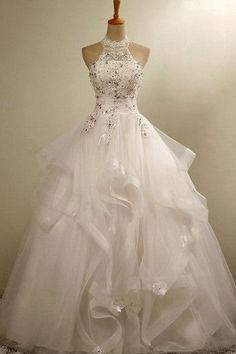 a white wedding dress on a mannequin