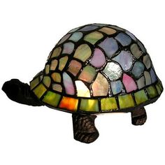 This Tiffany-Style Turtle Accent Lamp makes a pretty addition to your decor with its distinctive look. It features a colorful shell that complements a range of palettes with ease. The Warehouse of Tiffany lamp also has a bronze finish, adding a touch of sophistication. Display it on tables, shelves or bedside stands for simple illumination where you need it. The soft light and whimsical design is well-suited for a baby's nursery or child's bedroom. This item also makes a cute gift for a friend o Handcrafted Lamp, Tiffany Style Lamp, Globe Lamps, Louis Comfort Tiffany, Tiffany Lamps, Incandescent Lighting, Table Light