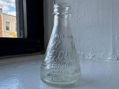 a glass bottle sitting on top of a window sill