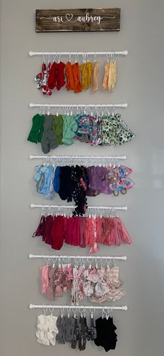 there are many baby clothes hanging on the wall