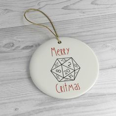 a white ornament with merry christmas written on it