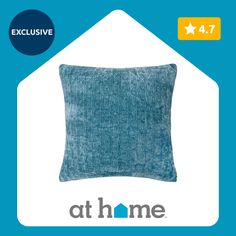 a blue pillow with the words at home on it and an image of a house