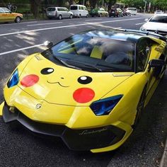 a yellow sports car with pikachu painted on it's hood parked in the street