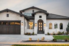 a large white house with two garage doors