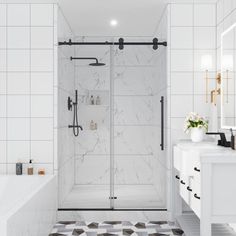 a white bathroom with black and white tile flooring on the shower wall, tub, and sink