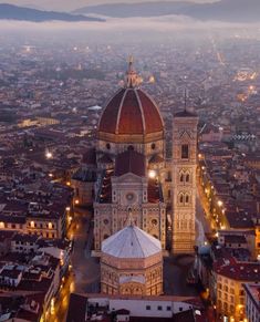 an aerial view of a large cathedral in the middle of a city at night time