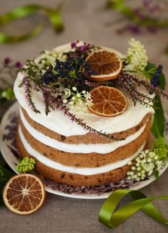 a cake decorated with orange slices and flowers