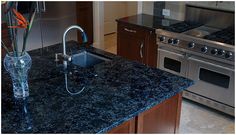 a kitchen with granite counter tops and stainless steel appliances