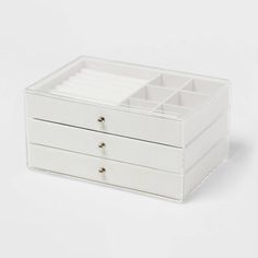 a white jewelry box with two drawers and three compartments on the bottom, one is open