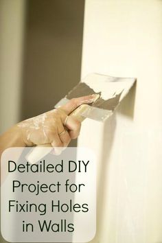 a person holding a piece of paper in their hand with text overlay that reads detailed diy project for fixing holes in walls