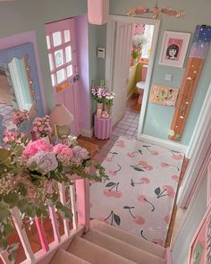 a pink and blue hallway with flowers on the stairs