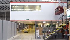 the inside of a warehouse with stairs and boxes