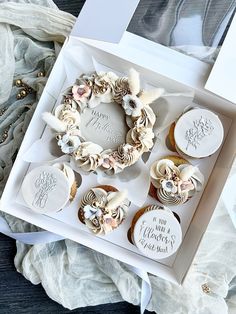 cupcakes in a box decorated with white frosting