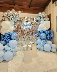 blue and silver balloons are on display in front of a mirror