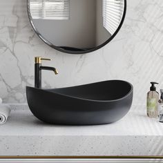 a bathroom sink sitting under a round mirror