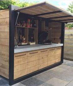 an outdoor kitchen made out of wood and metal