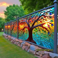 a decorative glass fence with a tree painted on it