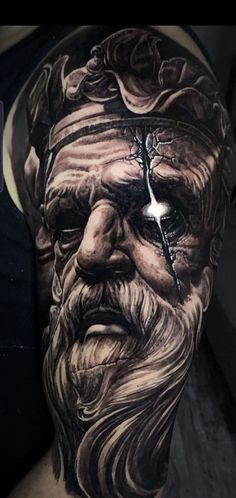 an old man with a cross in his face and beard is shown on the arm