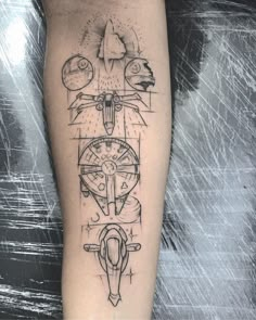 a person with a tattoo on their leg that has an image of a compass and other symbols