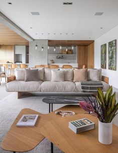 a living room filled with furniture and a wooden table in front of a wall mounted tv