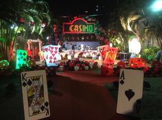 some cards are sitting on the ground in front of a casino sign and other decorations