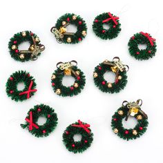 twelve christmas wreaths with bells and bells attached to each ornament are arranged in a circle