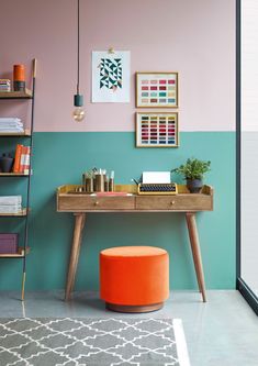 a desk with an orange ottoman in front of it