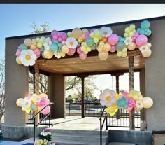 an entrance with balloons and flowers on it