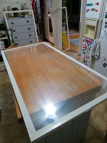 a kitchen counter with a light on it in a room filled with refrigerators and cabinets