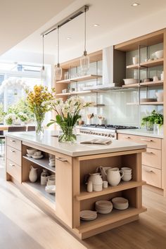 a kitchen filled with lots of wooden cabinets and counter top space next to a dining room table