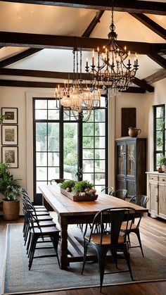 a dining room table with chairs and a chandelier hanging from it's ceiling