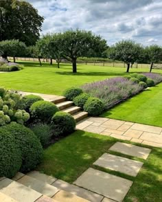 a garden with stone steps and green grass