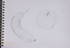 a pencil drawing of an apple next to a spirally shaped object on a white paper