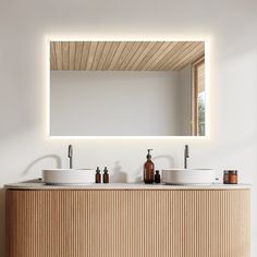 a bathroom with two sinks and a large mirror above it's countertop,