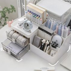 an organized desk with pens, pencils, and other office supplies on top of it