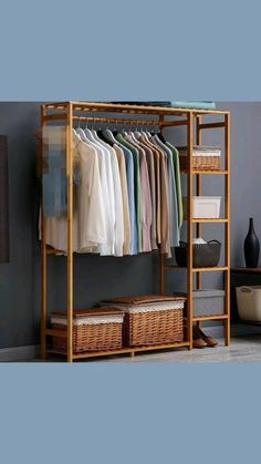 an open closet with clothes and baskets on the floor, next to a wall mounted shelf