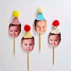 three children's birthday hats on top of toothpicks in the shape of faces