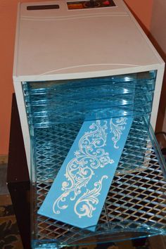 a small computer tower with a blue paper on the front and side panel, sitting on a glass table