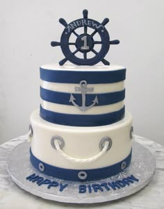 a birthday cake with an anchor and wheel on top