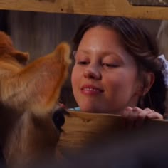 a woman is looking at a monkey in the zoo and it's nose is open