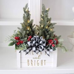 a white box filled with christmas decorations and greenery